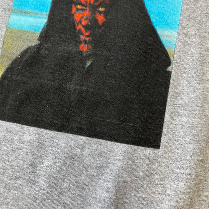 Supreme FW26 Darth Maul Sith Gray Tee features a black 90% cotton and 10% polyester T-shirt with a photo graphic of Darth Maul on a blue background. A white Supreme logo is printed above the graphic. Features a licensed Star Wars neck tag and is made in Honduras.