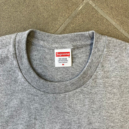 Supreme FW26 Darth Maul Sith Gray Tee features a black 90% cotton and 10% polyester T-shirt with a photo graphic of Darth Maul on a blue background. A white Supreme logo is printed above the graphic. Features a licensed Star Wars neck tag and is made in Honduras.