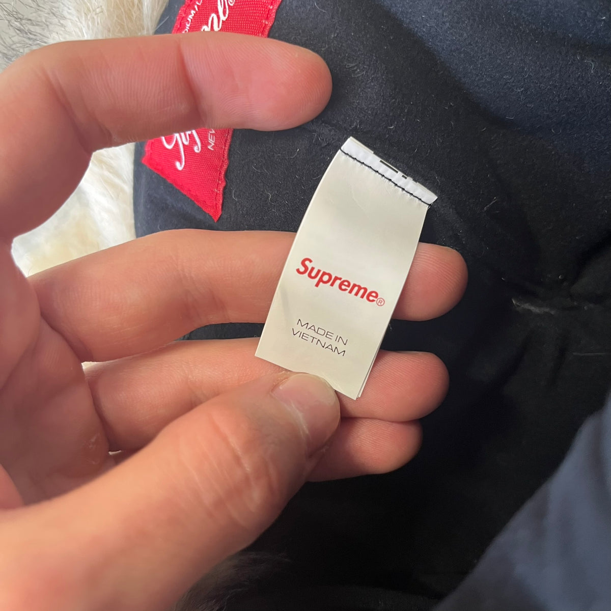 Supreme FW26 GORE-TEX Earflap Predator Camo Camp Cap is a waterproof, breathable camp cap made from GORE-TEX 2-layer poly ripstop in a white, black, and brown camo pattern. It features a black Supreme box logo on the front, an embroidered graphic on the side, and a strap closure. The cap is lined with polar fleece, and the earflaps are lined with faux fur.