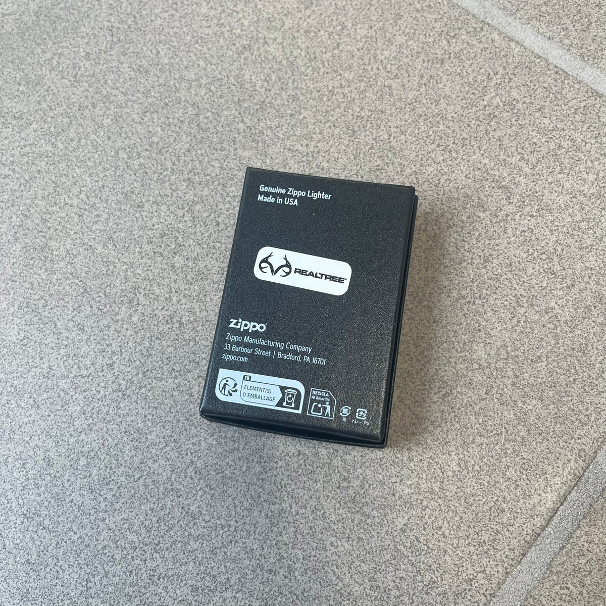 Supreme FW26 RealTree Camo Logo Zippo Lighter is an original Zippo featuring a full RealTree camo graphic with the Supreme box logo on the front. It comes with the original Zippo box and has never been filled.