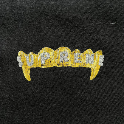 Supreme Fronts SS19 Black Tee released on February 21, 2019, as part of the brand’s Spring/Summer 2019 collection. Crafted from 100% cotton, it features a gold grill design with diamond fangs and a jeweled Supreme logo across the teeth. A standout graphic tee from Supreme’s early SS19 lineup.