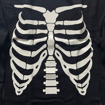 Supreme Hanes Bones Thermal Crew from FW25, crafted from 100% cotton in black with white bone graphics. Features a ribcage-inspired skeleton print on the front, matching arm bone designs on the sleeves, and a small Supreme logo near the hem. Released on October 23, 2025.