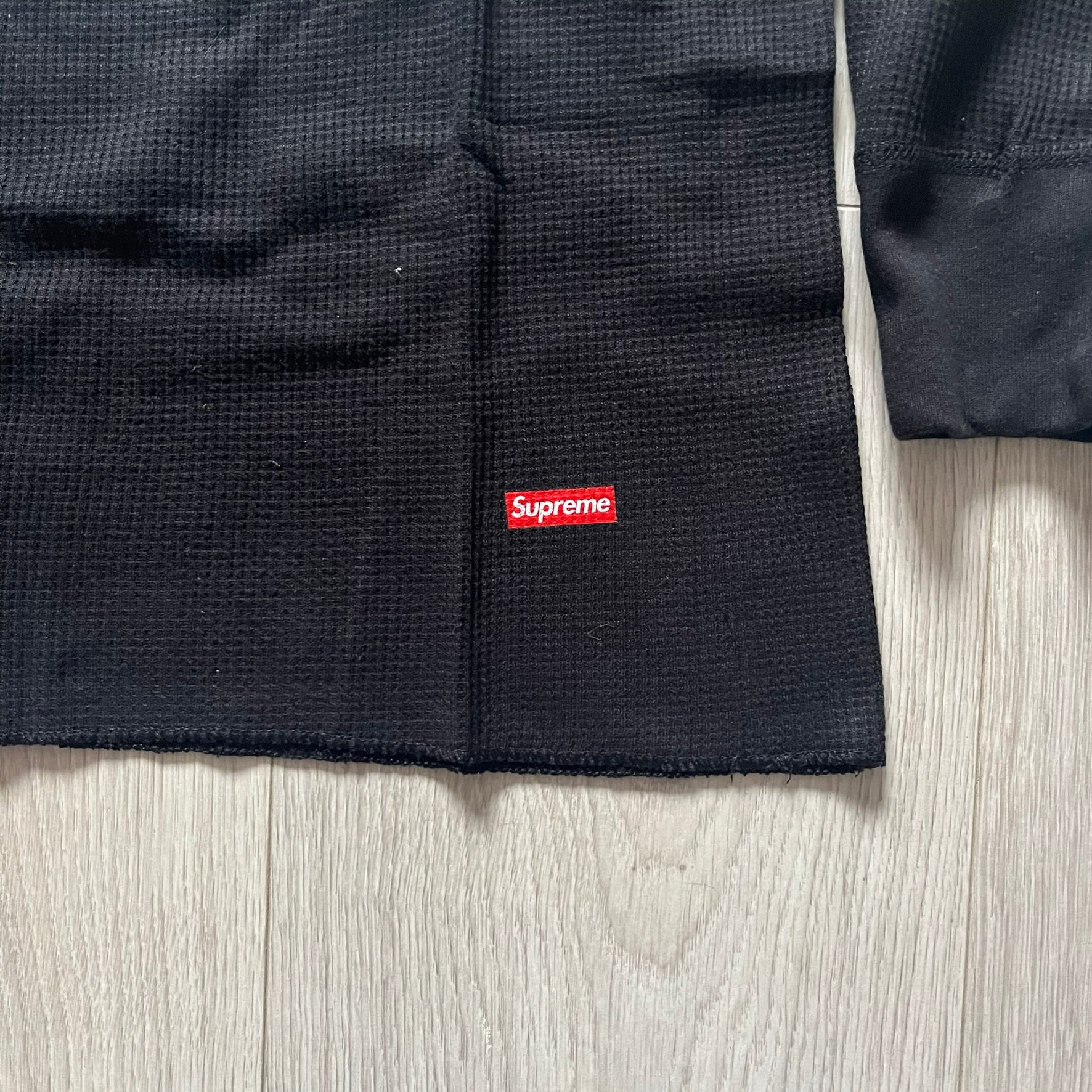 Supreme Hanes Bones Thermal Crew from FW25, crafted from 100% cotton in black with white bone graphics. Features a ribcage-inspired skeleton print on the front, matching arm bone designs on the sleeves, and a small Supreme logo near the hem. Released on October 23, 2025.