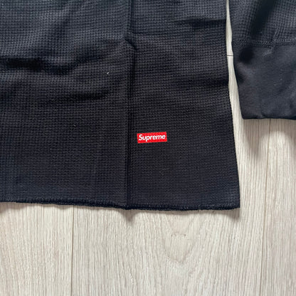 Supreme Hanes Bones Thermal Crew from FW25, crafted from 100% cotton in black with white bone graphics. Features a ribcage-inspired skeleton print on the front, matching arm bone designs on the sleeves, and a small Supreme logo near the hem. Released on October 23, 2025.