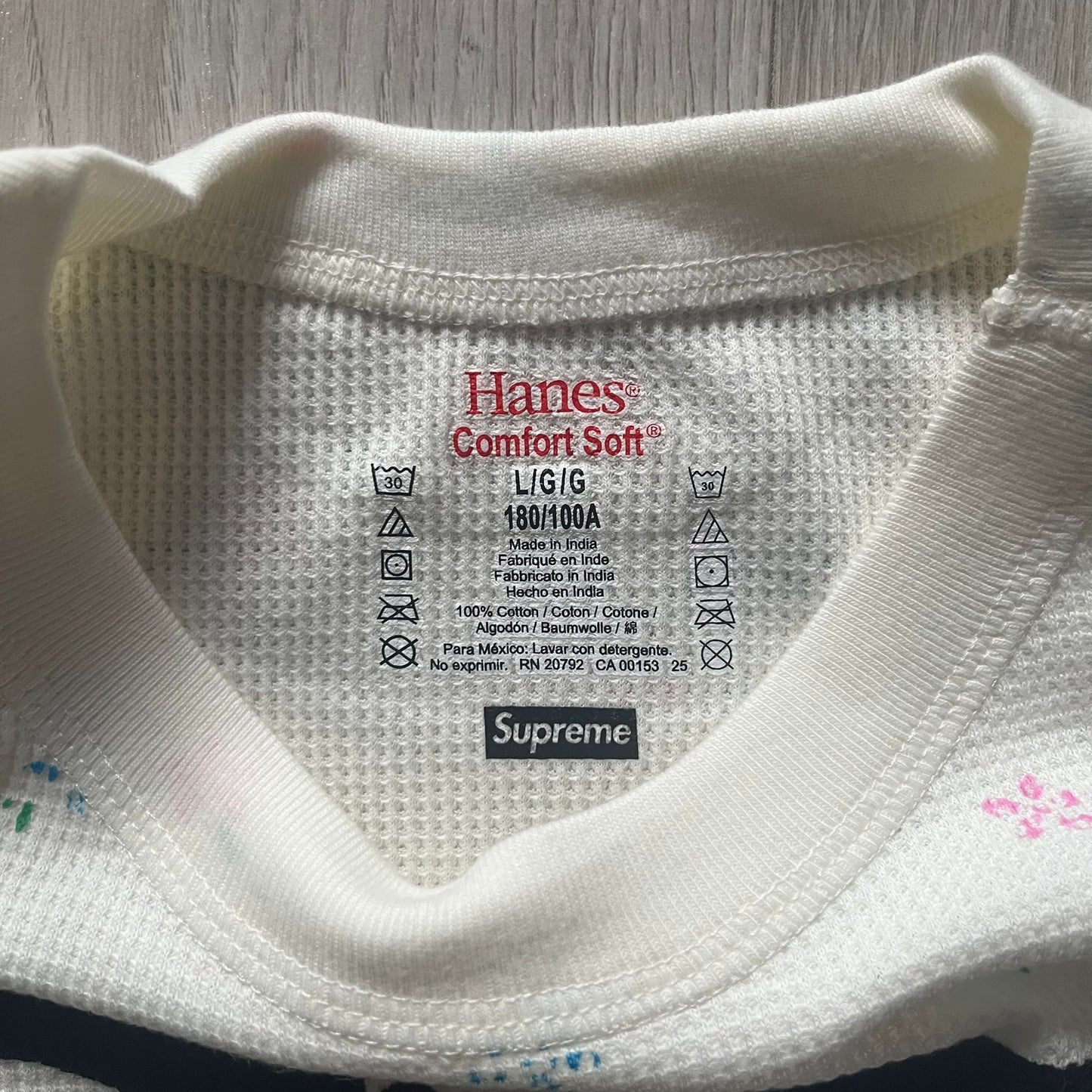 Supreme Hanes Bones Thermal Crew from FW25, crafted from 100% cotton in natural/white with black bone graphics and small floral all over print. Features a ribcage-inspired skeleton print on the front, matching arm bone designs on the sleeves, and a small Supreme logo near the hem. Released on October 23, 2025.