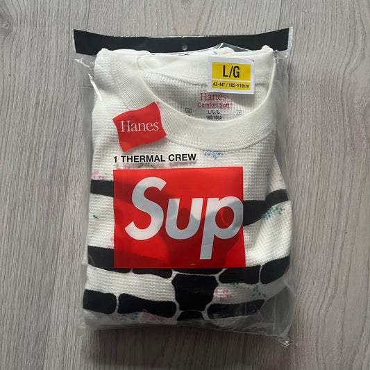 Supreme Hanes Bones Thermal Crew from FW25, crafted from 100% cotton in natural/white with black bone graphics and small floral all over print. Features a ribcage-inspired skeleton print on the front, matching arm bone designs on the sleeves, and a small Supreme logo near the hem. Released on October 23, 2025.