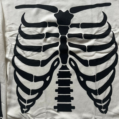 Supreme Hanes Bones Thermal Crew from FW25, crafted from 100% cotton in natural/white with black bone graphics. Features a ribcage-inspired skeleton print on the front, matching arm bone designs on the sleeves, and a small Supreme logo near the hem. Released on October 23, 2025.