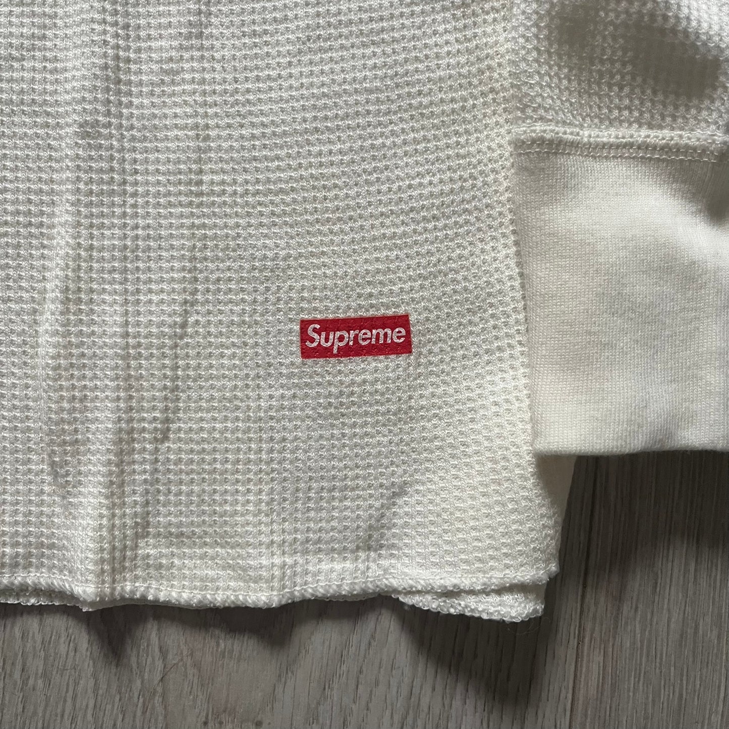 Supreme Hanes Bones Thermal Crew from FW25, crafted from 100% cotton in natural/white with black bone graphics. Features a ribcage-inspired skeleton print on the front, matching arm bone designs on the sleeves, and a small Supreme logo near the hem. Released on October 23, 2025.