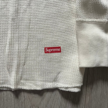 Supreme Hanes Bones Thermal Crew from FW25, crafted from 100% cotton in natural/white with black bone graphics. Features a ribcage-inspired skeleton print on the front, matching arm bone designs on the sleeves, and a small Supreme logo near the hem. Released on October 23, 2025.