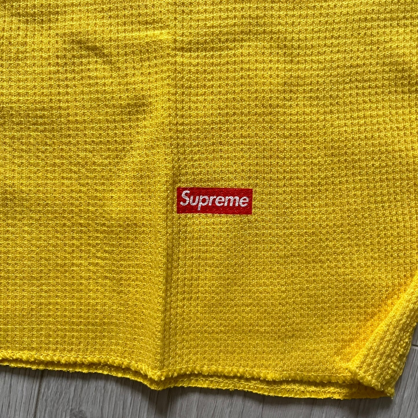 Supreme Hanes Bones Thermal Crew from FW25, crafted from 100% cotton in yellow with black bone graphics. Features a ribcage-inspired skeleton print on the front, matching arm bone designs on the sleeves, and a small Supreme logo near the hem. Released on October 23, 2025.