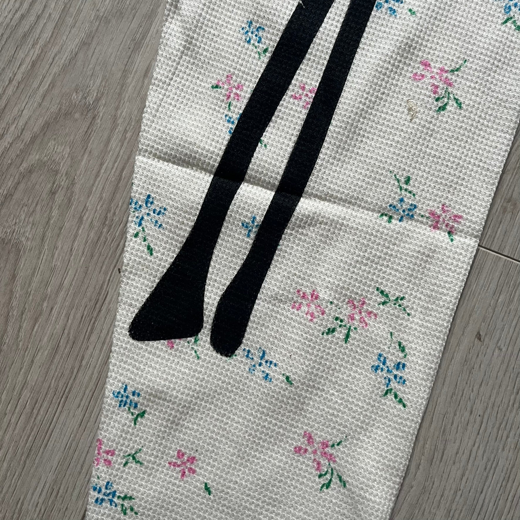 Supreme Hanes Bones Thermal Pant FW25 in natural/white with small floral all over print, crafted from 100% cotton. Features black skeletal bone prints running down both legs and a red elastic waistband with white Supreme branding throughout. Released October 23, 2025.