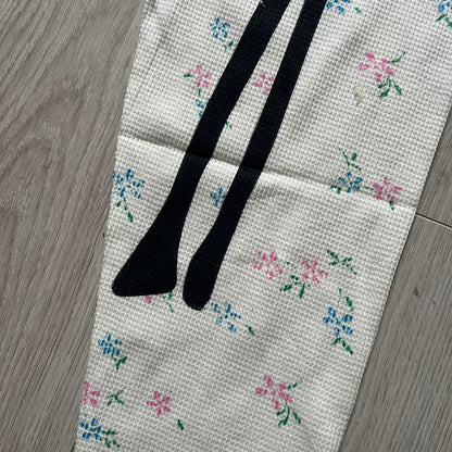 Supreme Hanes Bones Thermal Pant FW25 in natural/white with small floral all over print, crafted from 100% cotton. Features black skeletal bone prints running down both legs and a red elastic waistband with white Supreme branding throughout. Released October 23, 2025.