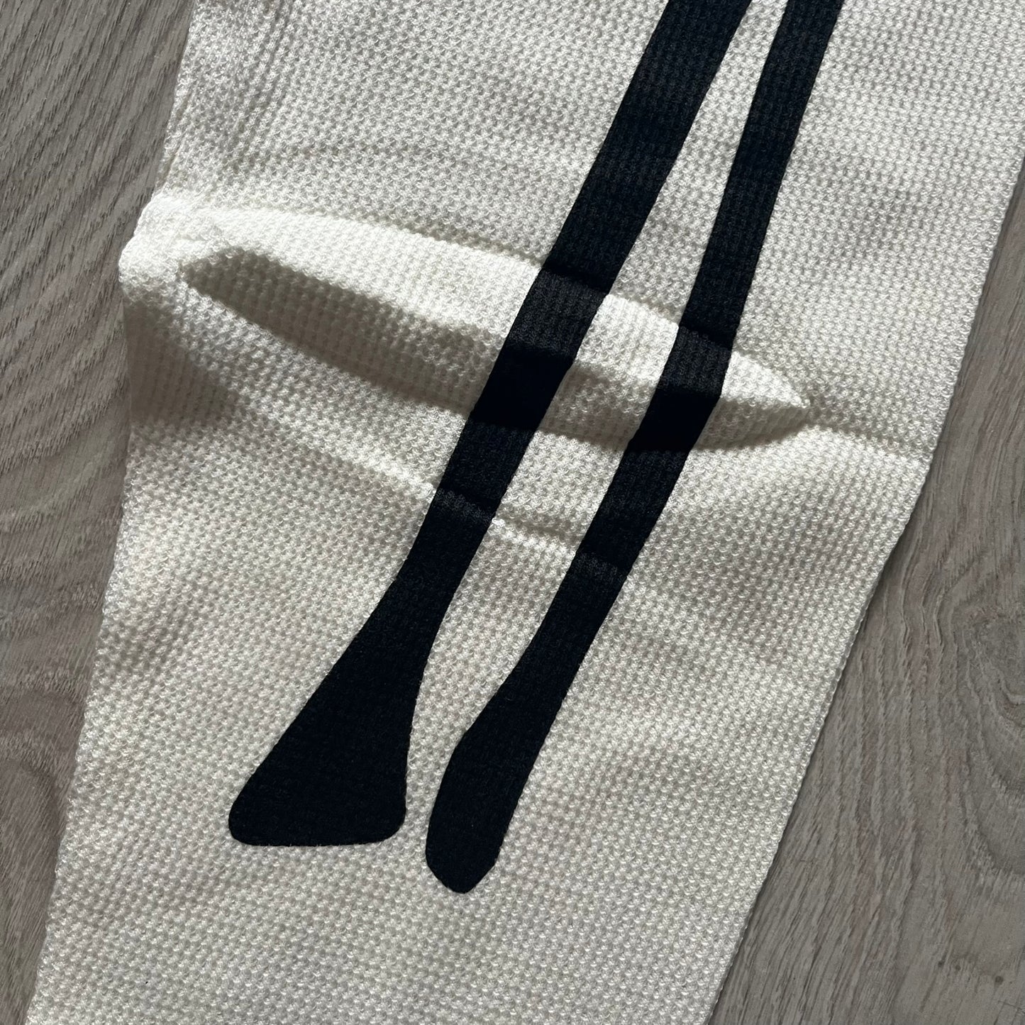 Supreme Hanes Bones Thermal Pant FW25 in natural/white, crafted from 100% cotton. Features black skeletal bone prints running down both legs and a red elastic waistband with white Supreme branding throughout. Released October 23, 2025.