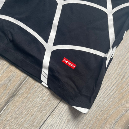 Supreme Hanes SS26 Spider-Man Black Tagless Tee is a black all-cotton crewneck T-shirt from the Spring/Summer 2026 collection, produced on a Hanes tagless blank. The shirt features an all-over white web print covering the front, back, and sleeves, with a small red Supreme stamp logo printed near the bottom corner.