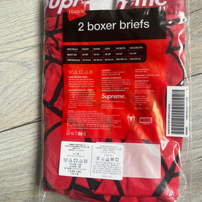 Supreme Hanes SS26 Spider-Man Red Boxer Briefs are made of cotton with a stretch fit. Features a red elastic waistband with white Supreme logo text and an all-over black web print. Classic Hanes base model a Spider-Man twist.