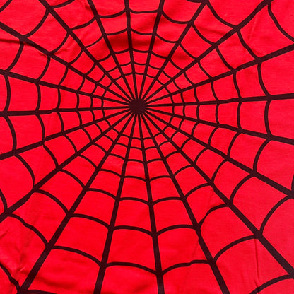 Supreme Hanes SS26 Spider-Man Red Tagless Tee is a red all-cotton crewneck T-shirt from the Spring/Summer 2026 collection, produced on a Hanes tagless blank. The shirt features an all-over black web print covering the front, back, and sleeves, with a small red Supreme stamp logo printed near the bottom corner.
