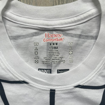 Supreme Hanes SS26 Spider-Man White Tagless Tee is a white all-cotton crewneck T-shirt from the Spring/Summer 2026 collection, produced on a Hanes tagless blank. The shirt features an all-over black web print covering the front, back, and sleeves, with a small red Supreme stamp logo printed near the bottom corner.