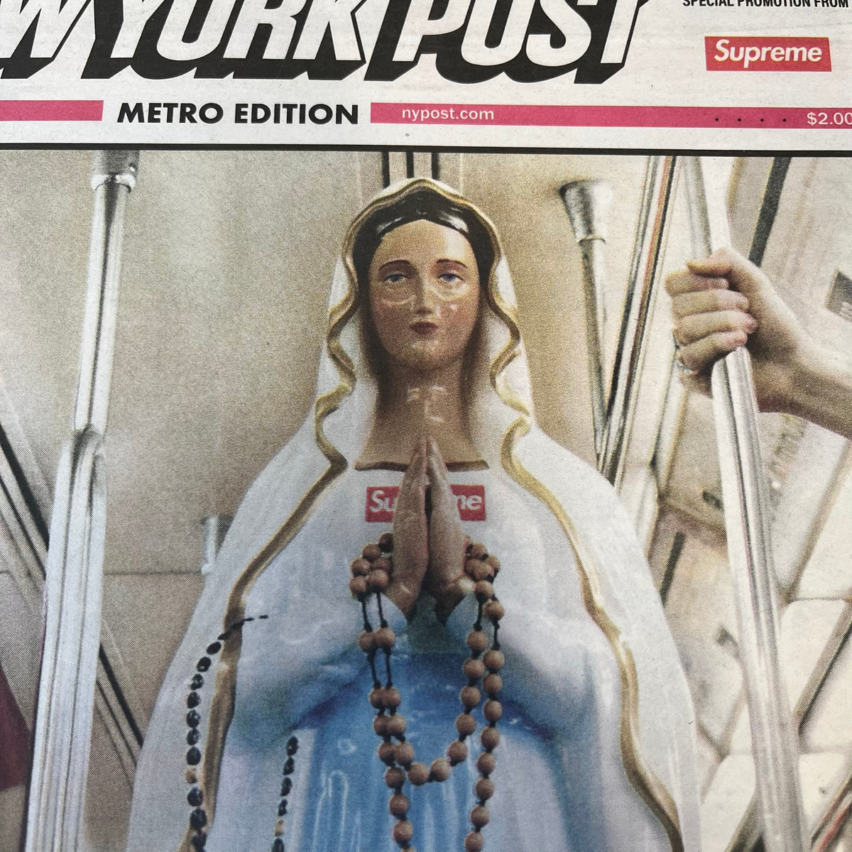 Supreme New York Post Newspaper “Late City Final Edition” from Fall/Winter 2026, released on August 17th, 2026. Features the features a religious statue with iconic Supreme box logo printed on it. On the back there's a "Deliver US From Evil". Includes the full original newspaper, with only the cover designed by Supreme.