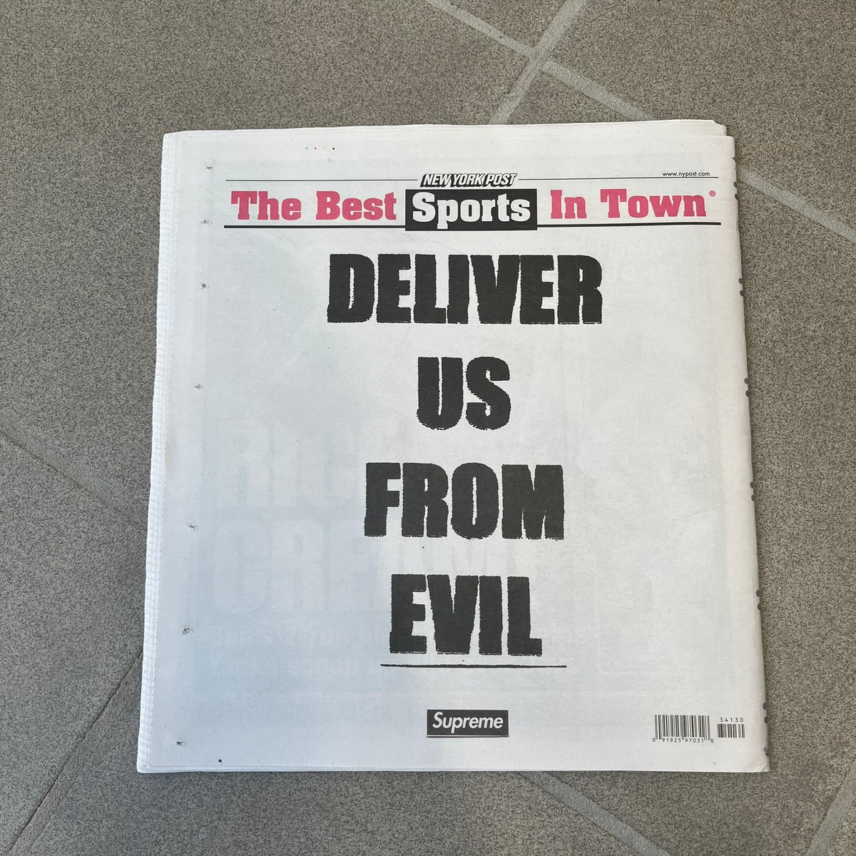 Supreme New York Post Newspaper “Late City Final Edition” from Fall/Winter 2026, released on August 17th, 2026. Features the features a religious statue with iconic Supreme box logo printed on it. On the back there's a "Deliver US From Evil". Includes the full original newspaper, with only the cover designed by Supreme.