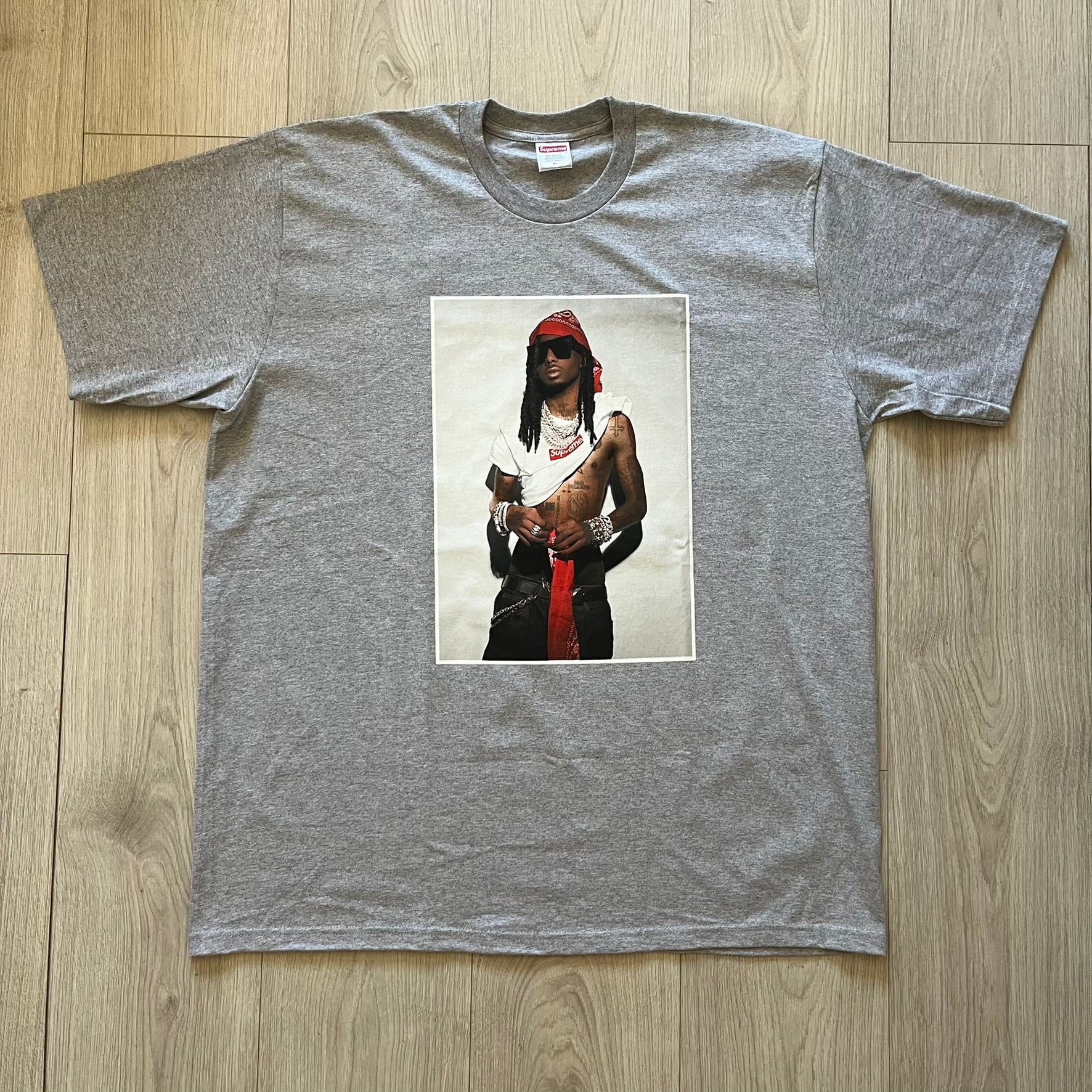 Supreme Playboi Carti photo tee in Heather Gray from the FW25 collection, featuring a large front print of the influential rapper. Crafted from soft cotton, it merges Supreme’s iconic photo tee format with Carti’s distinct cultural presence.