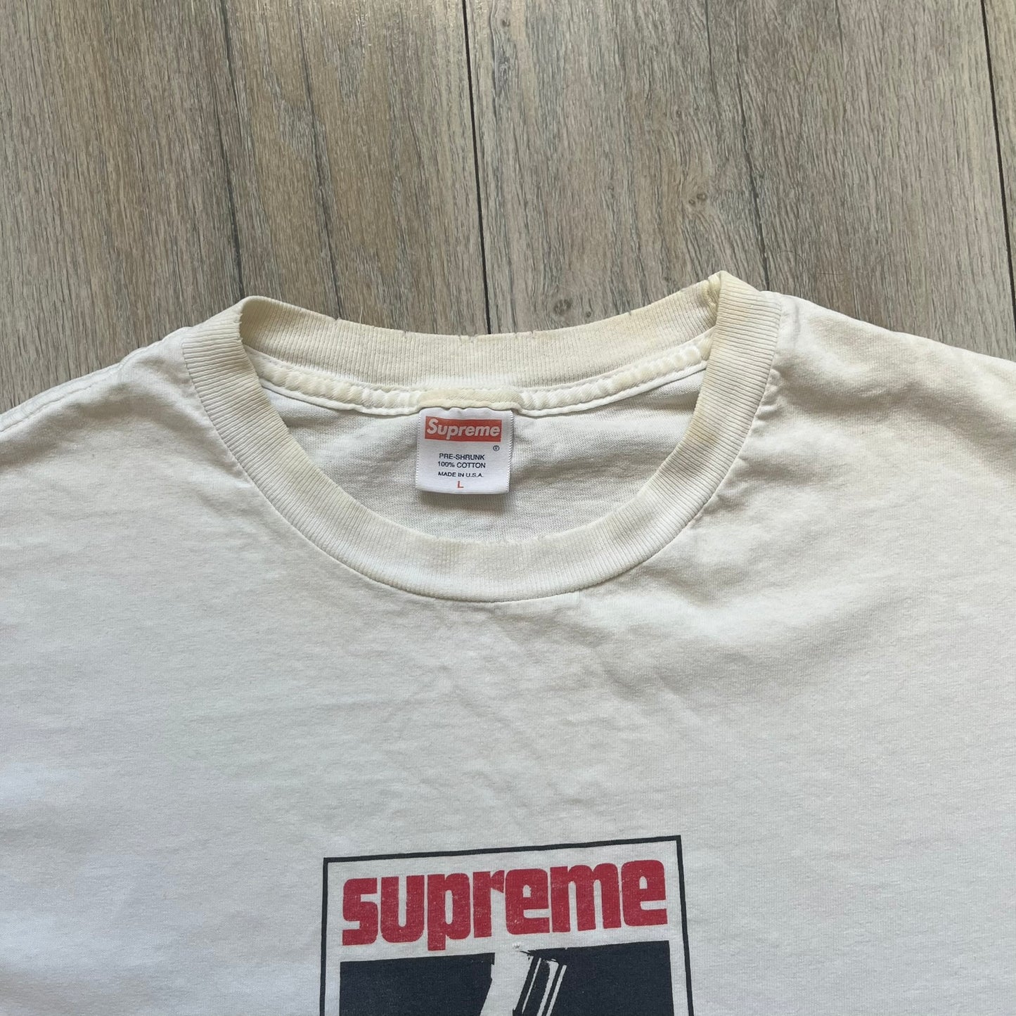 Supreme SS05 STAX Records White Gun Tee is a white short-sleeve T-shirt from the Spring/Summer 2005 collection. The front features a modified Stax Records-inspired logo with “Supreme” in red and a hand holding a gun graphic. This piece is super rare.