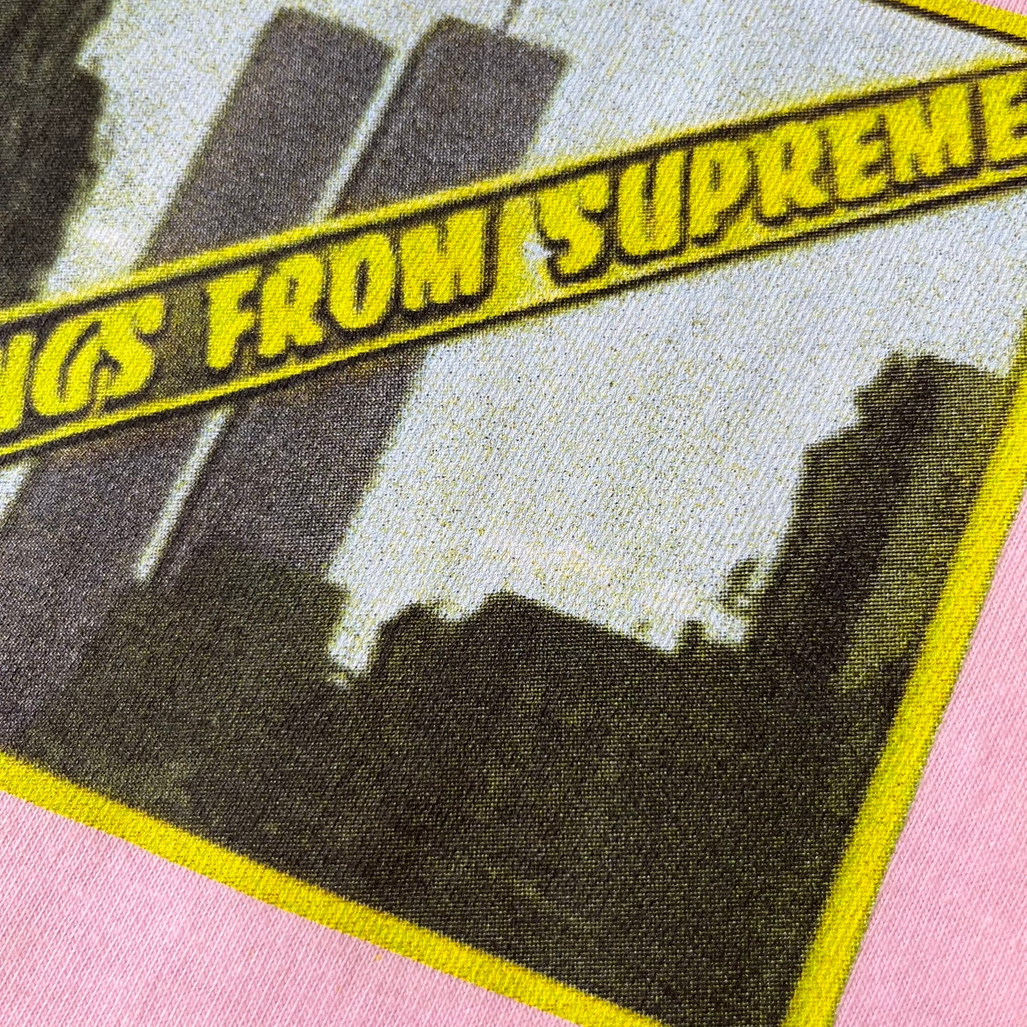 Supreme SS19 Greetings Pink Tee features a pink T-shirt with a front graphic designed as a greeting card showing the New York City skyline. The graphic includes the text “Greetings From Supreme” and depicts the original skyline with the Twin Towers. Released as part of Supreme’s Spring/Summer 2019 collection. Made in USA, 100% Cotton.
