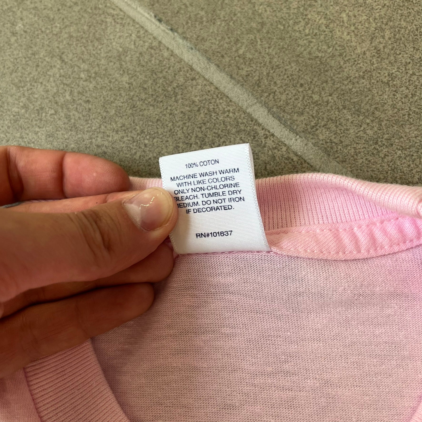 Supreme SS19 Greetings Pink Tee features a pink T-shirt with a front graphic designed as a greeting card showing the New York City skyline. The graphic includes the text “Greetings From Supreme” and depicts the original skyline with the Twin Towers. Released as part of Supreme’s Spring/Summer 2019 collection. Made in USA, 100% Cotton.
