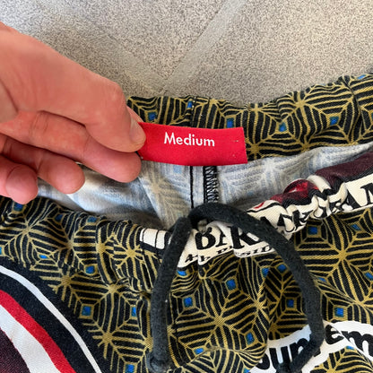 Supreme SS2017 Obama Green Pants are green/olive pants with the all-over patchwork print incorporating Barack Obama’s face, the words “Barack Obama,” and scattered Supreme logos. The design pays homage to the “khanas,” vibrant patterned garments with political graphics made by local designers in Ghana to commemorate the former president’s 2009 visit. They have two front pockets and one back pocket.