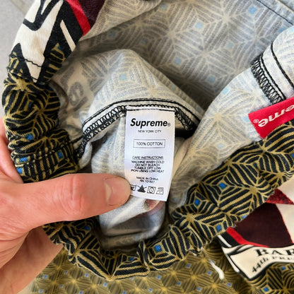 Supreme SS2017 Obama Green Pants are green/olive pants with the all-over patchwork print incorporating Barack Obama’s face, the words “Barack Obama,” and scattered Supreme logos. The design pays homage to the “khanas,” vibrant patterned garments with political graphics made by local designers in Ghana to commemorate the former president’s 2009 visit. They have two front pockets and one back pocket.