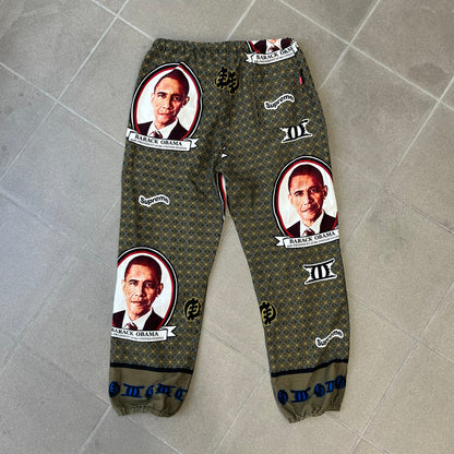 Supreme SS2017 Obama Green Pants are green/olive pants with the all-over patchwork print incorporating Barack Obama’s face, the words “Barack Obama,” and scattered Supreme logos. The design pays homage to the “khanas,” vibrant patterned garments with political graphics made by local designers in Ghana to commemorate the former president’s 2009 visit. They have two front pockets and one back pocket.
