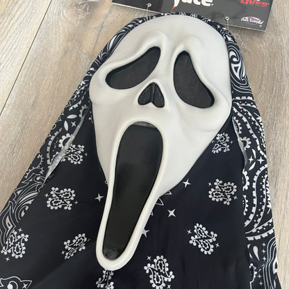 Supreme SS26 Ghostface Mask is a PVC face mask released on April 30, 2026, as part of the Spring/Summer 2026 collection. The mask features the classic white Ghostface design, combined with a black fabric hood element covered in white bandana-style patterns and integrated Supreme tags. Additional hanging strips on the sides enhance the hooded visual effect.
