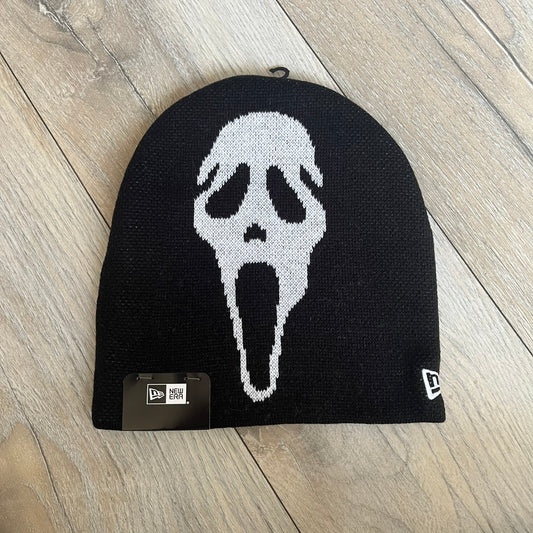 Supreme SS26 New Era Ghostface Black Beanie is a black knit beanie released on March 26, 2026, as part of the Spring/Summer 2026 collection. The front features a white Ghostface graphic, while the back includes “Supreme” text in a gothic-style font, with a small New Era logo embroidered on the side. The beanie is constructed from knit fabric for warmth and everyday wear.