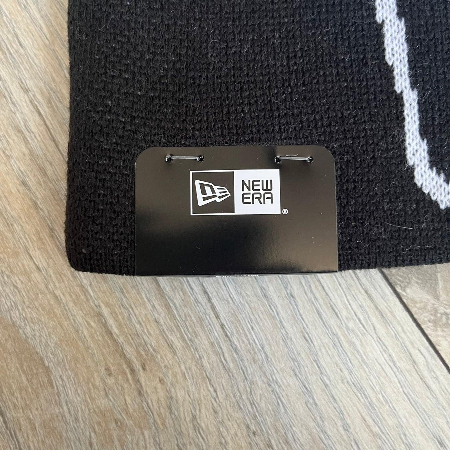 Supreme SS26 New Era Ghostface Black Beanie is a black knit beanie released on March 26, 2026, as part of the Spring/Summer 2026 collection. The front features a white Ghostface graphic, while the back includes “Supreme” text in a gothic-style font, with a small New Era logo embroidered on the side. The beanie is constructed from knit fabric for warmth and everyday wear.
