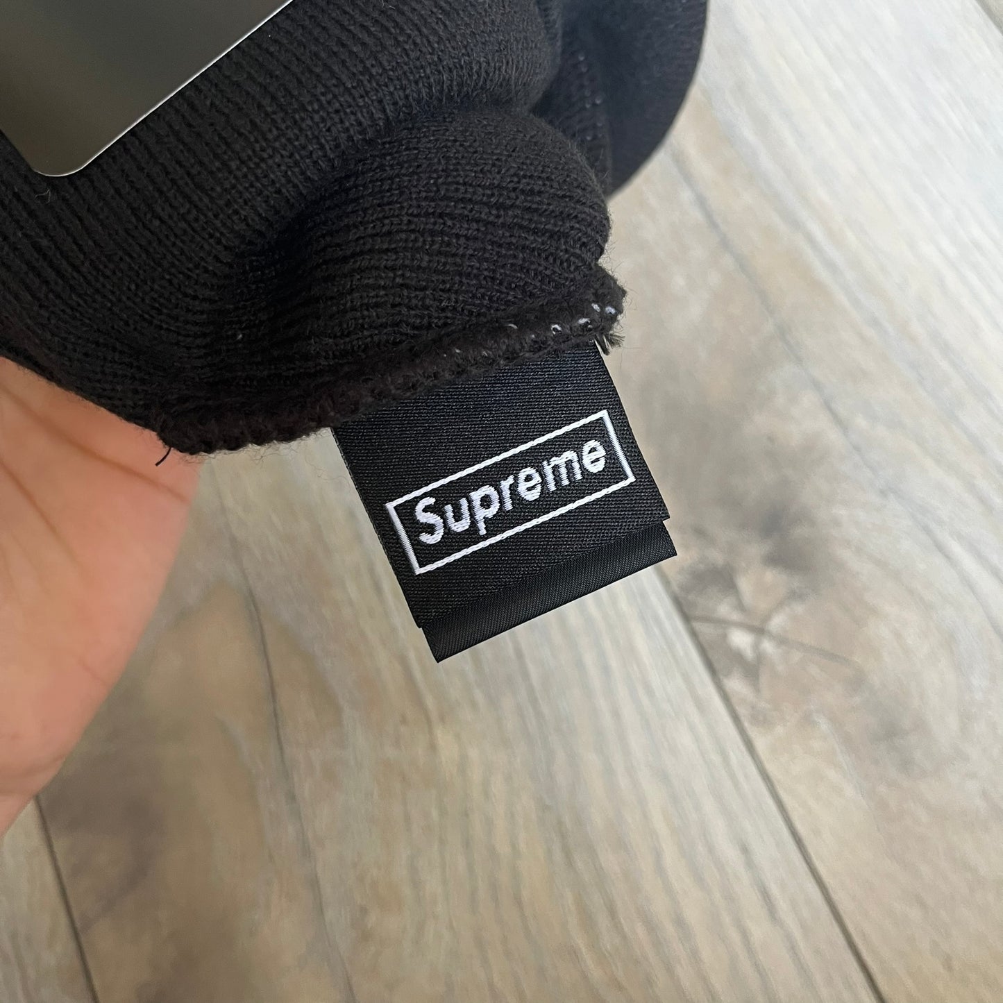 Supreme SS26 New Era Ghostface Black Beanie is a black knit beanie released on March 26, 2026, as part of the Spring/Summer 2026 collection. The front features a white Ghostface graphic, while the back includes “Supreme” text in a gothic-style font, with a small New Era logo embroidered on the side. The beanie is constructed from knit fabric for warmth and everyday wear.