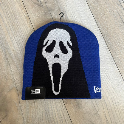 Supreme SS26 New Era Ghostface Black Beanie is a Royal (Blue) knit beanie released on March 26, 2026, as part of the Spring/Summer 2026 collection. The front features a white and black Ghostface graphic, while the back includes “Supreme” text in a gothic-style font, with a small New Era logo embroidered on the side. The beanie is constructed from knit fabric for warmth and everyday wear.