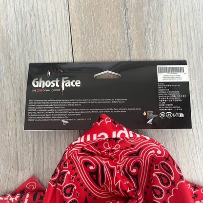 Supreme SS26 Ghostface Mask is a PVC face mask released on April 30, 2026, as part of the Spring/Summer 2026 collection. The mask features the classic white Ghostface design, combined with a red fabric hood element covered in white and black bandana-style patterns and integrated Supreme tags. Additional hanging strips on the sides enhance the hooded visual effect.