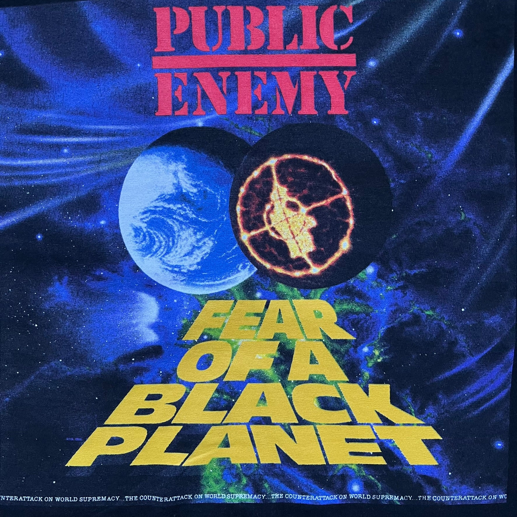 Supreme Undercover Public Enemy Counterattack SS18 Longsleeve Tee is a black long-sleeve T-shirt released on March 15, 2018, crafted from 100% cotton. The front features white “The Counterattack On World Supremacy” text with a small Supreme UNDERCOVER logo beneath, while the back displays a large Public Enemy “Fear of a Black Planet” graphic with galaxy and planet imagery and the same co-branded logo below. The design includes a ribbed crewneck and ribbed cuffs, reflecting the SS18 collaboration between Sup