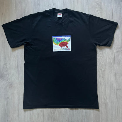 Supreme “Weather” FW23 tee in black, showcasing a satirical weather map graphic of the USA. Below sits a gradient bar in red-to-pink tones, with every category marked “Shitty.” Includes small Supreme New York text detail, true to the collection.
