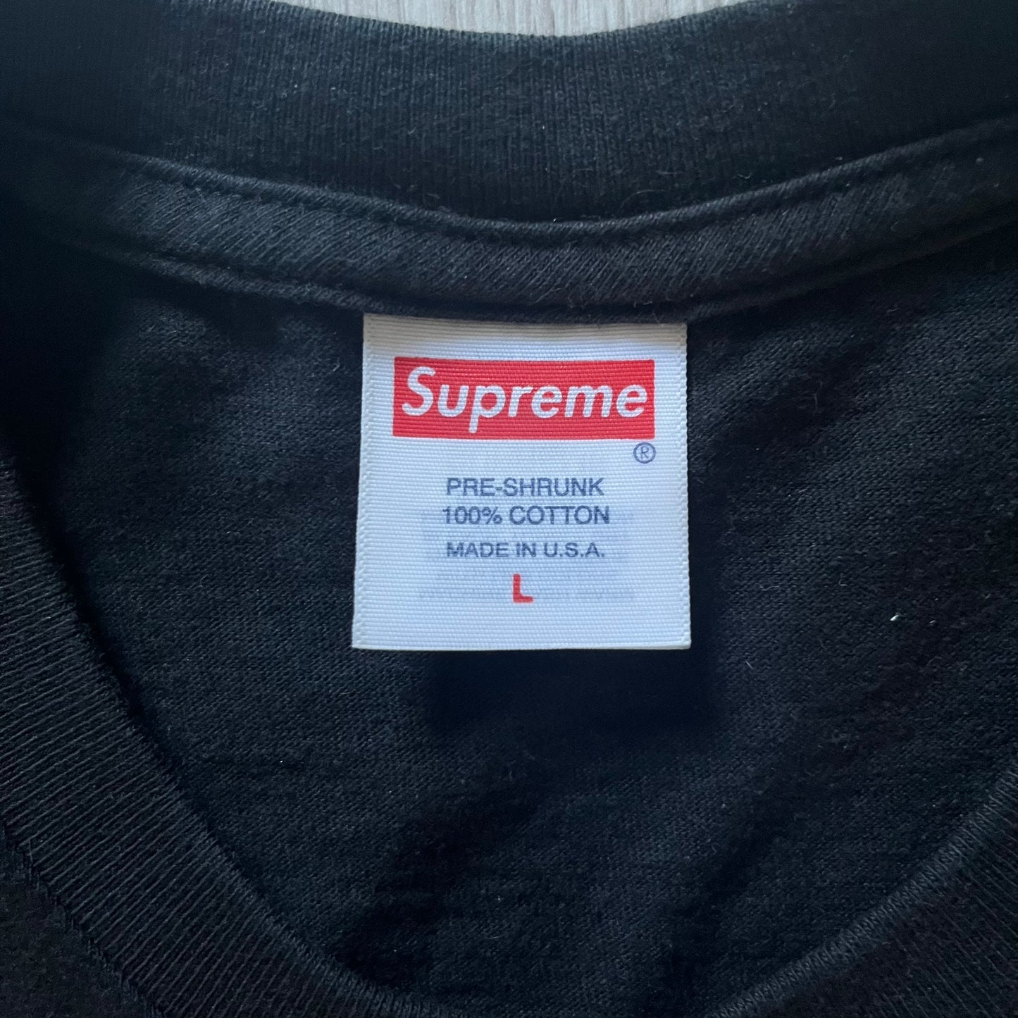 Supreme “Weather” FW23 tee in black, showcasing a satirical weather map graphic of the USA. Below sits a gradient bar in red-to-pink tones, with every category marked “Shitty.” Includes small Supreme New York text detail, true to the collection.