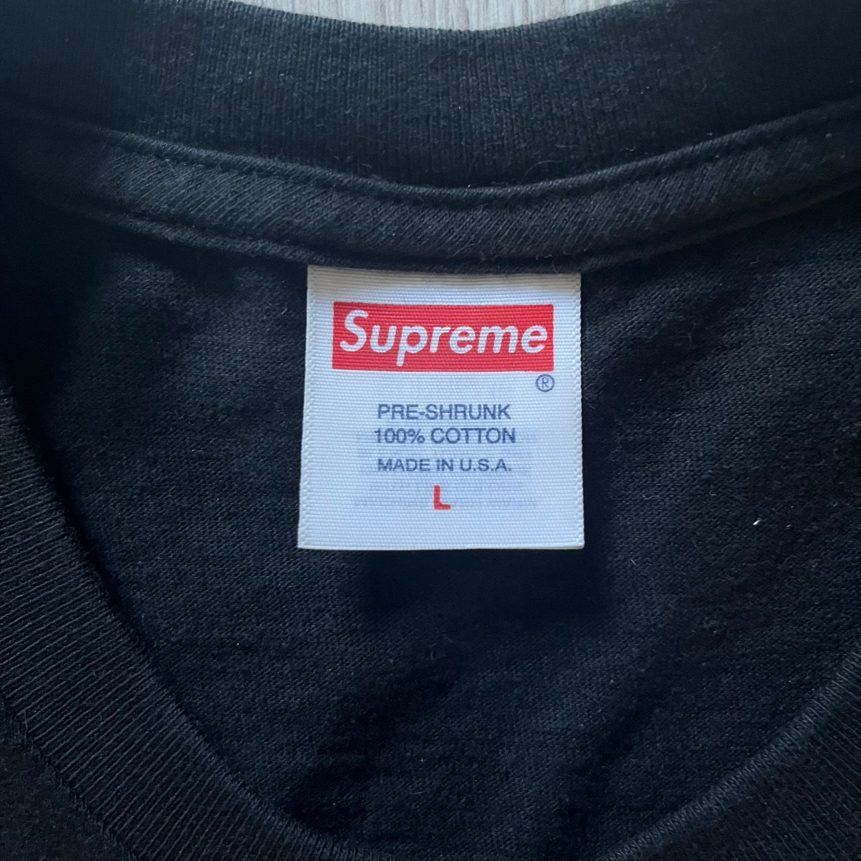 Supreme “Weather” FW23 tee in black, showcasing a satirical weather map graphic of the USA. Below sits a gradient bar in red-to-pink tones, with every category marked “Shitty.” Includes small Supreme New York text detail, true to the collection.