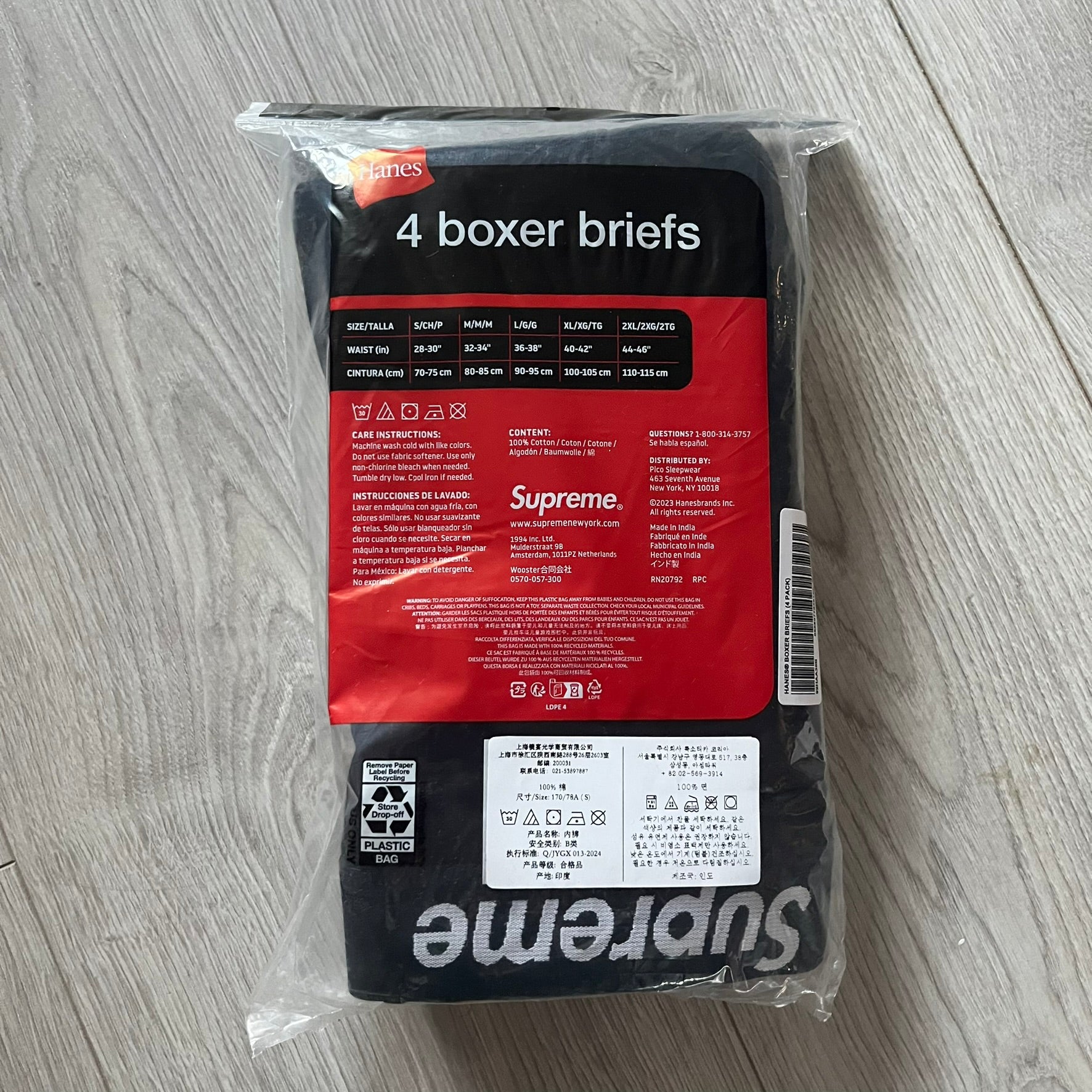 Supreme x Hanes black boxer briefs made of cotton with a stretch fit. Features a black elastic waistband with white Supreme logo text in Futura Oblique font. Classic Hanes base model with co-branded detailing.