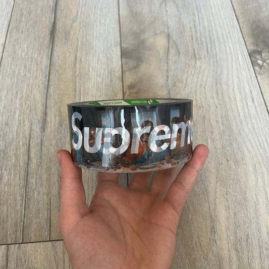Supreme x Nichiban Packing Tape Multicolor is a single roll of durable packing tape released as part of the Spring/Summer 2026 collection on May 21, 2026. Made in Japan exclusively for Supreme, the tape features a multicolor background with repeating white Supreme box logo prints across the surface. Designed as both a functional accessory and collectible branded item.