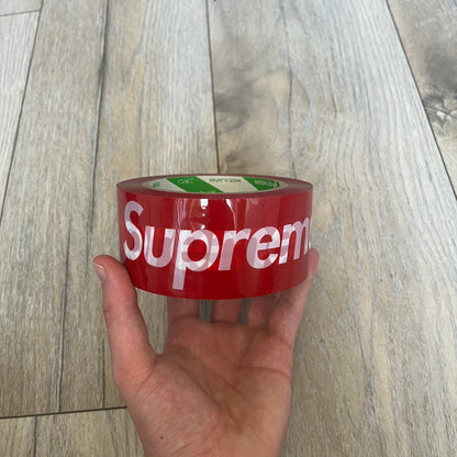 Supreme x Nichiban Packing Tape Red is a single roll of durable packing tape released as part of the Spring/Summer 2026 collection on May 21, 2026. Made in Japan exclusively for Supreme, the tape features an all-over red design with repeating white Supreme box logo prints. The roll is designed for practical use while also functioning as a collectible branded accessory.