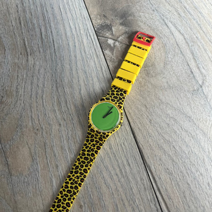 Swatch x Jeremy Scott 2011 Punk Analog Watch GZ251 is a quartz watch from the Gent Original line featuring a bright green dial with black hands and a plastic case. The design includes a comically long silicone strap with leopard print that wraps twice around the wrist, secured with multiple yellow loops, and Jeremy Scott branding on the upper strap. The watch is water resistant to 3 bar and comes with original box and papers