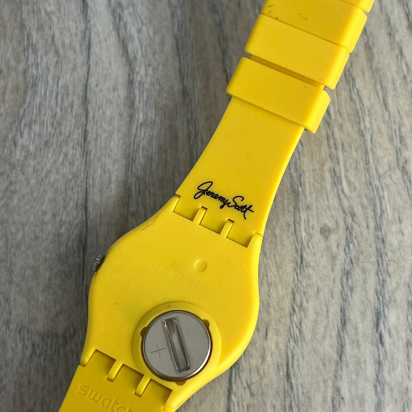 Swatch x Jeremy Scott 2011 Punk Analog Watch GZ251 is a quartz watch from the Gent Original line featuring a bright green dial with black hands and a plastic case. The design includes a comically long silicone strap with leopard print that wraps twice around the wrist, secured with multiple yellow loops, and Jeremy Scott branding on the upper strap. The watch is water resistant to 3 bar and comes with original box and papers