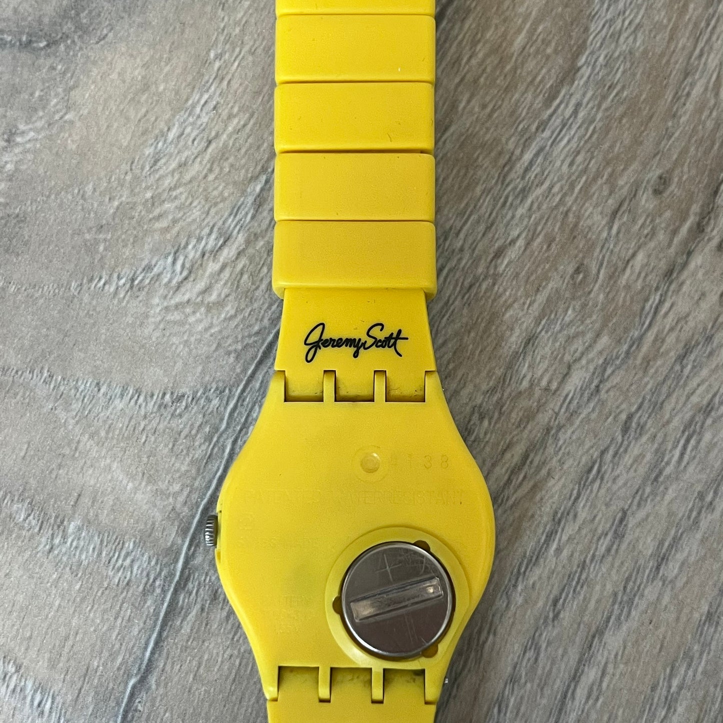 Swatch x Jeremy Scott 2011 Punk Analog Watch GZ251 is a quartz watch from the Gent Original line featuring a bright green dial with black hands and a plastic case. The design includes a comically long silicone strap with leopard print that wraps twice around the wrist, secured with multiple yellow loops, and Jeremy Scott branding on the upper strap. The watch is water resistant to 3 bar and comes with original box and papers.