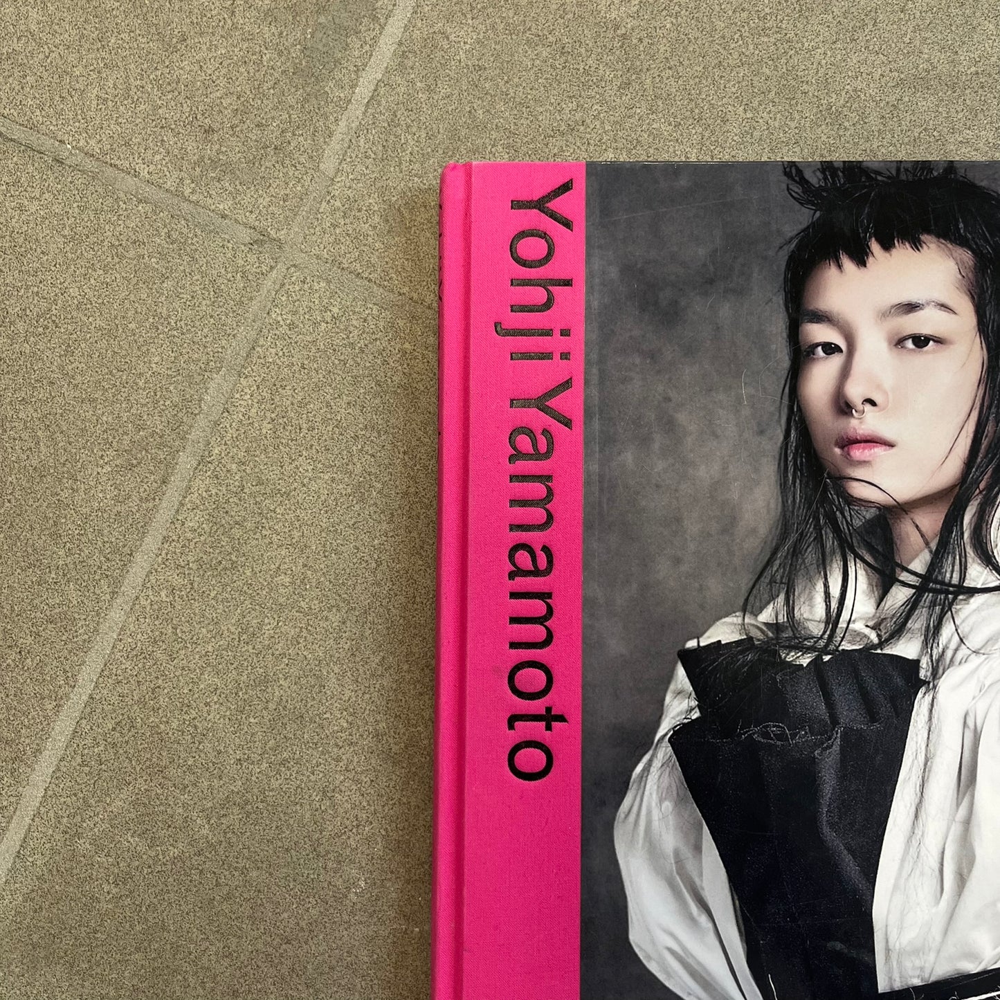 Taschen *Yohji Yamamoto* Hardcover Book is a hardcover publication curated by Terry Jones, exploring the groundbreaking work and career of Yohji Yamamoto. The 120-page book features photography, biographical content, and rare visuals drawn from more than 30 years of i-D magazine archives, along with personal insights into the designer’s work and influence.
