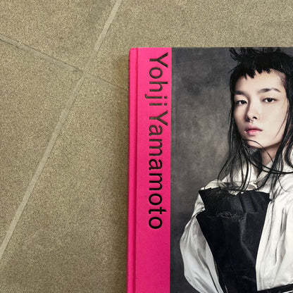 Taschen *Yohji Yamamoto* Hardcover Book is a hardcover publication curated by Terry Jones, exploring the groundbreaking work and career of Yohji Yamamoto. The 120-page book features photography, biographical content, and rare visuals drawn from more than 30 years of i-D magazine archives, along with personal insights into the designer’s work and influence.

