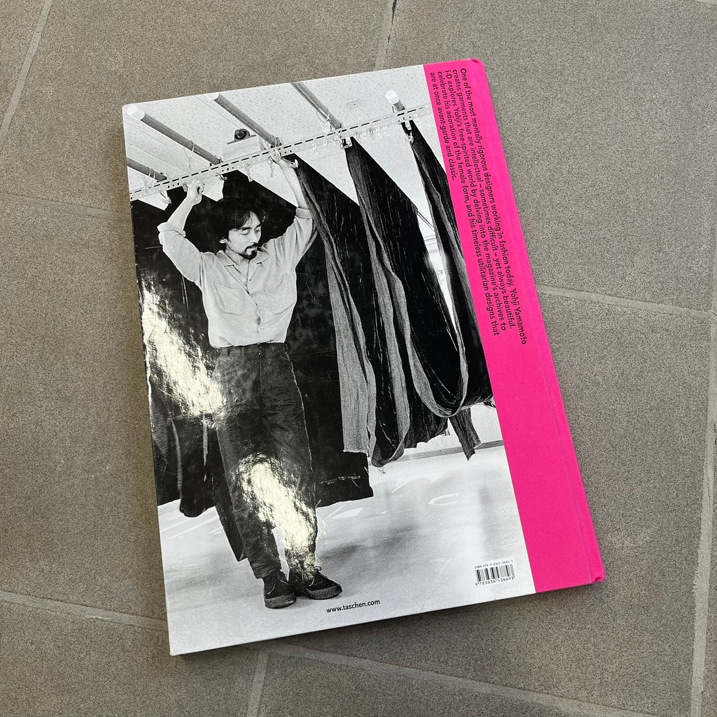 Taschen *Yohji Yamamoto* Hardcover Book is a hardcover publication curated by Terry Jones, exploring the groundbreaking work and career of Yohji Yamamoto. The 120-page book features photography, biographical content, and rare visuals drawn from more than 30 years of i-D magazine archives, along with personal insights into the designer’s work and influence.
