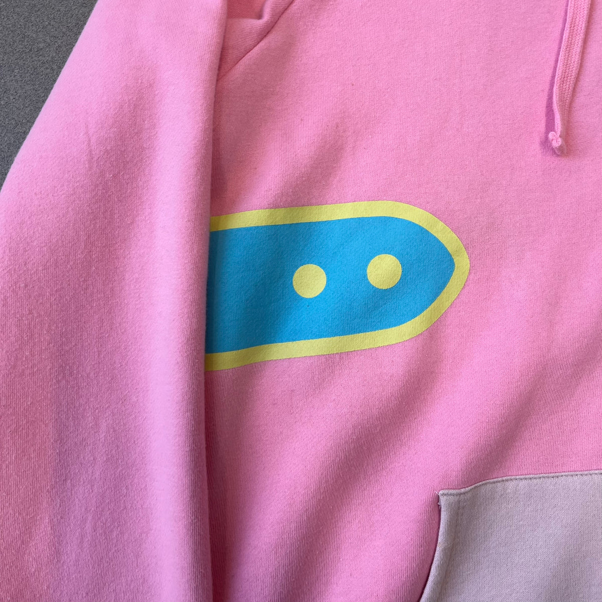 Team Fortress 2 Balloonicorn 2015 WeLoveFine Zip-Up Hoodie is a bright pink unisex colorblock hoodie from Valve’s Team Fortress 2 line, with a detailed 3D plush Balloonicorn hood featuring embroidered eyes, a 3D horn, nose, and ears. It has front pockets, a custom metal Balloonicorn cameo zipper pull, and a light blue printed saddle graphic that wraps from the back to the front. The licensed TF2 neck tag carries 2015 and We Love Fine branding. Super rare.